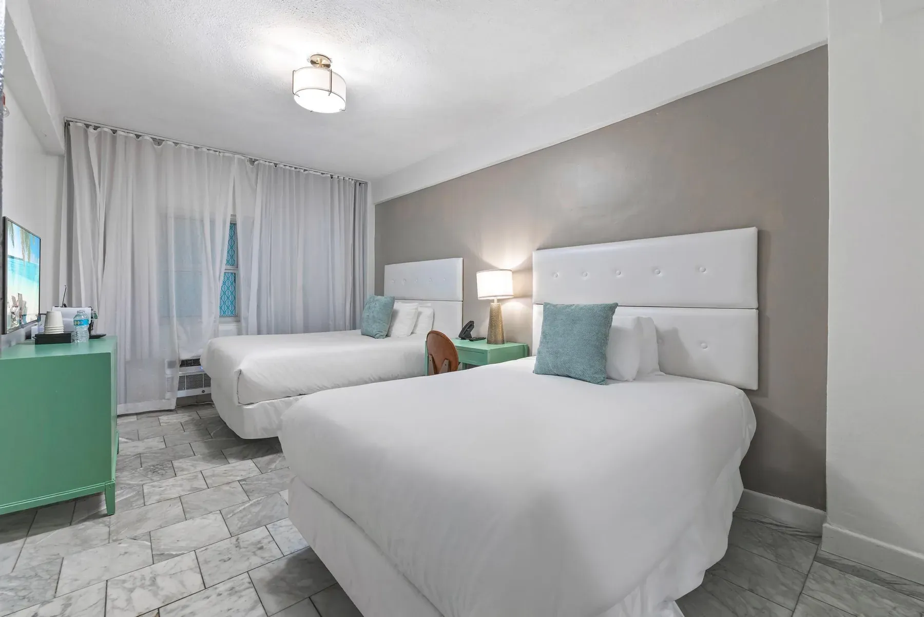 The room seen from the window end, two double beds and clear floor space between them