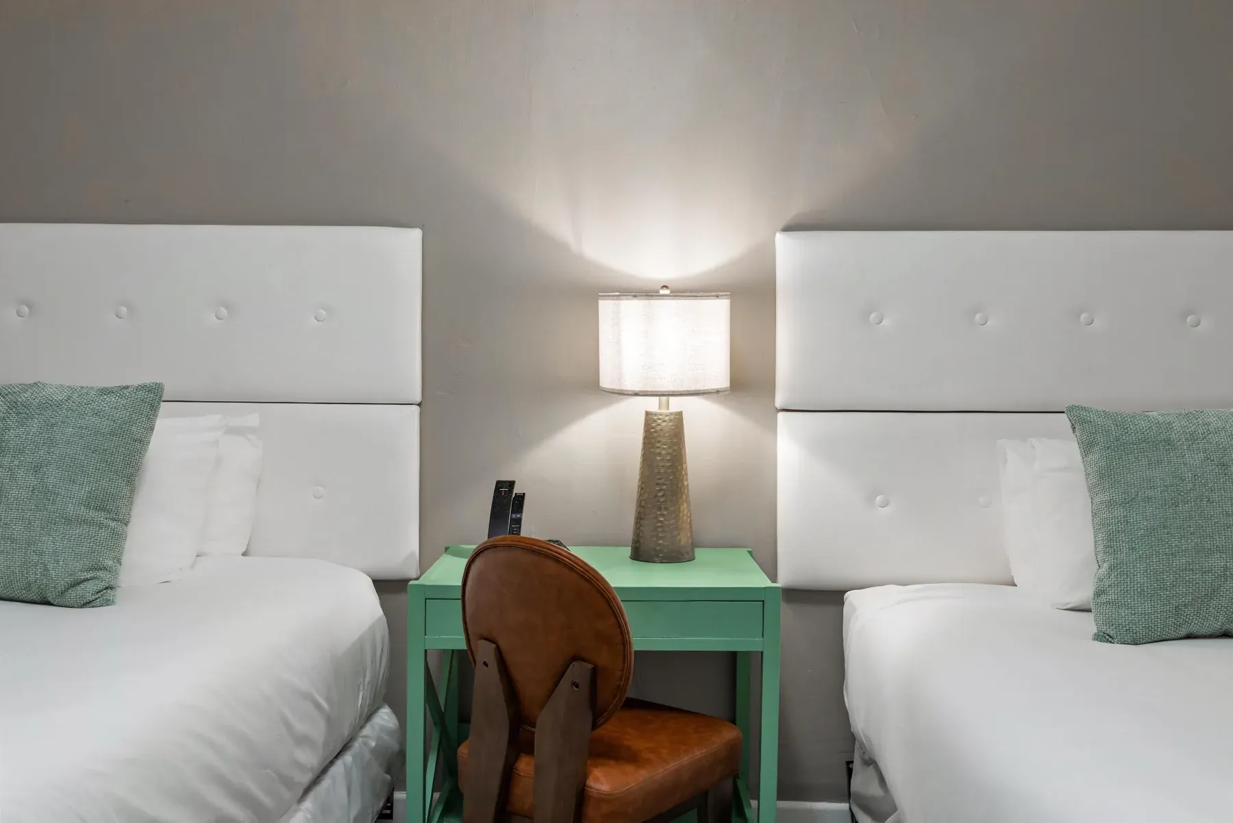 Between the beds, the lamp, desk chair and side table
