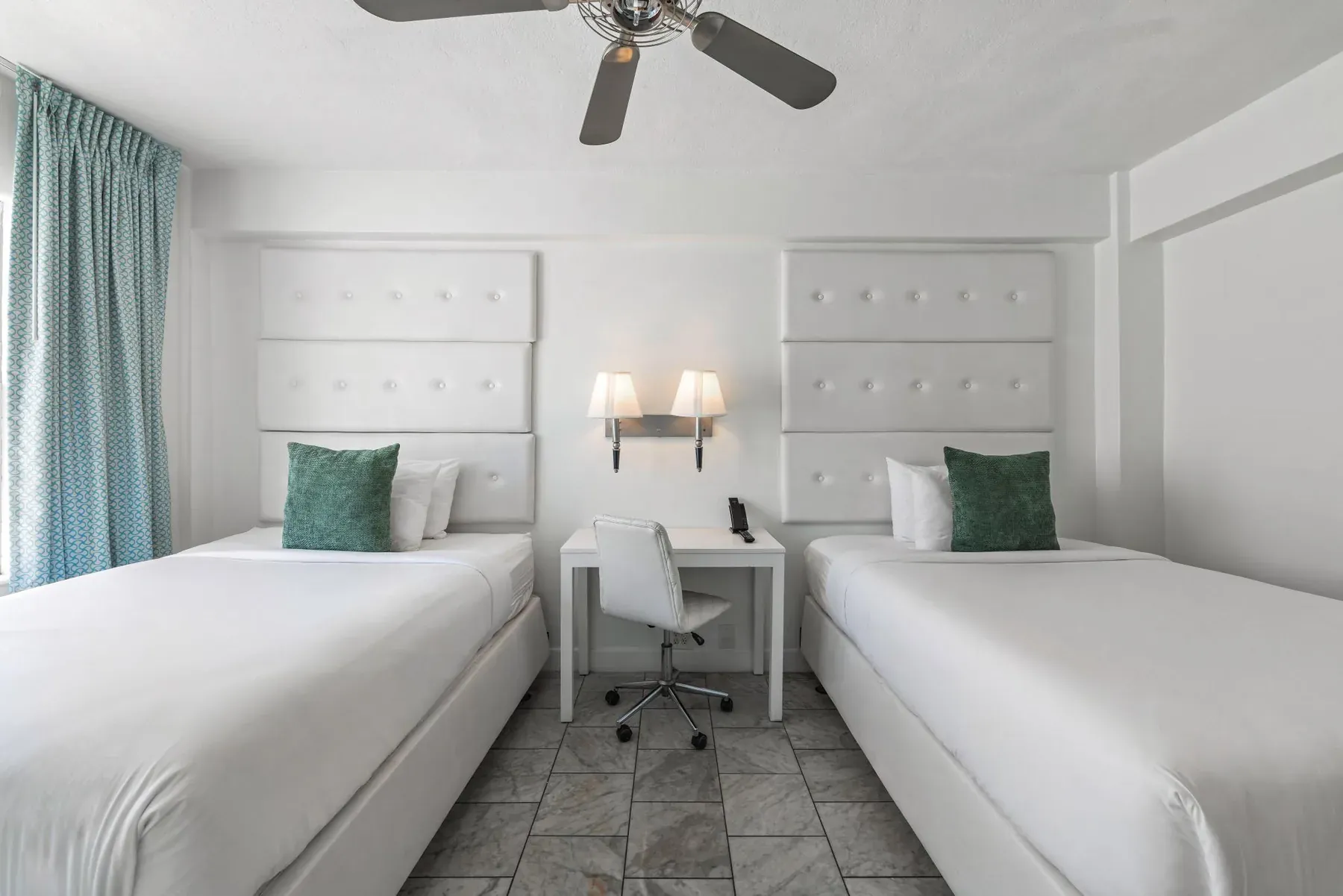 Both double beds head-on with the desk and chair between them