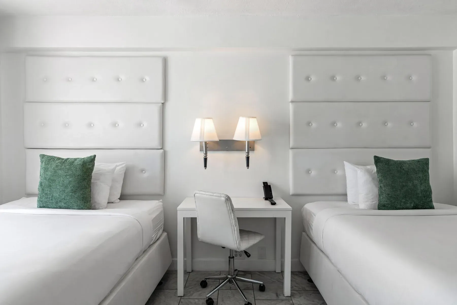 The desk and chair set between the two beds