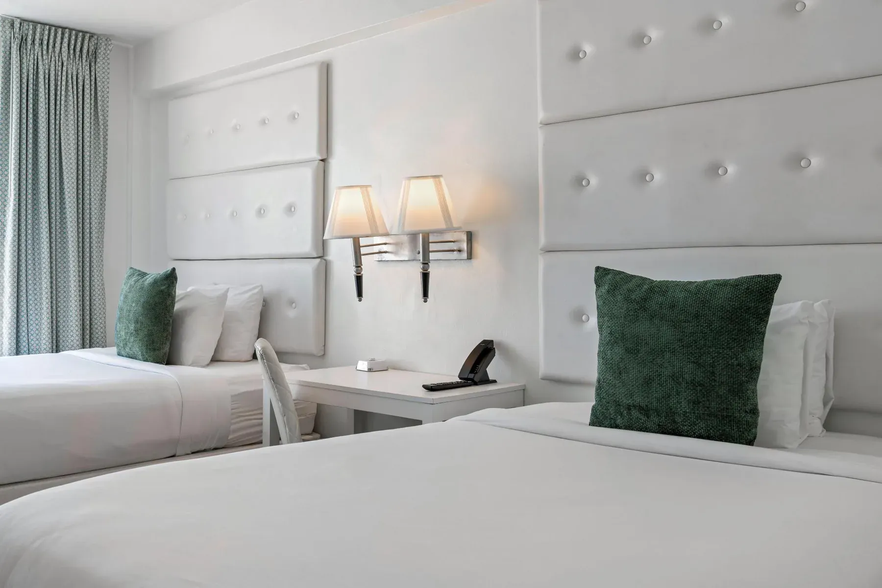 Bedside detail, wall sconce and buttoned headboard
