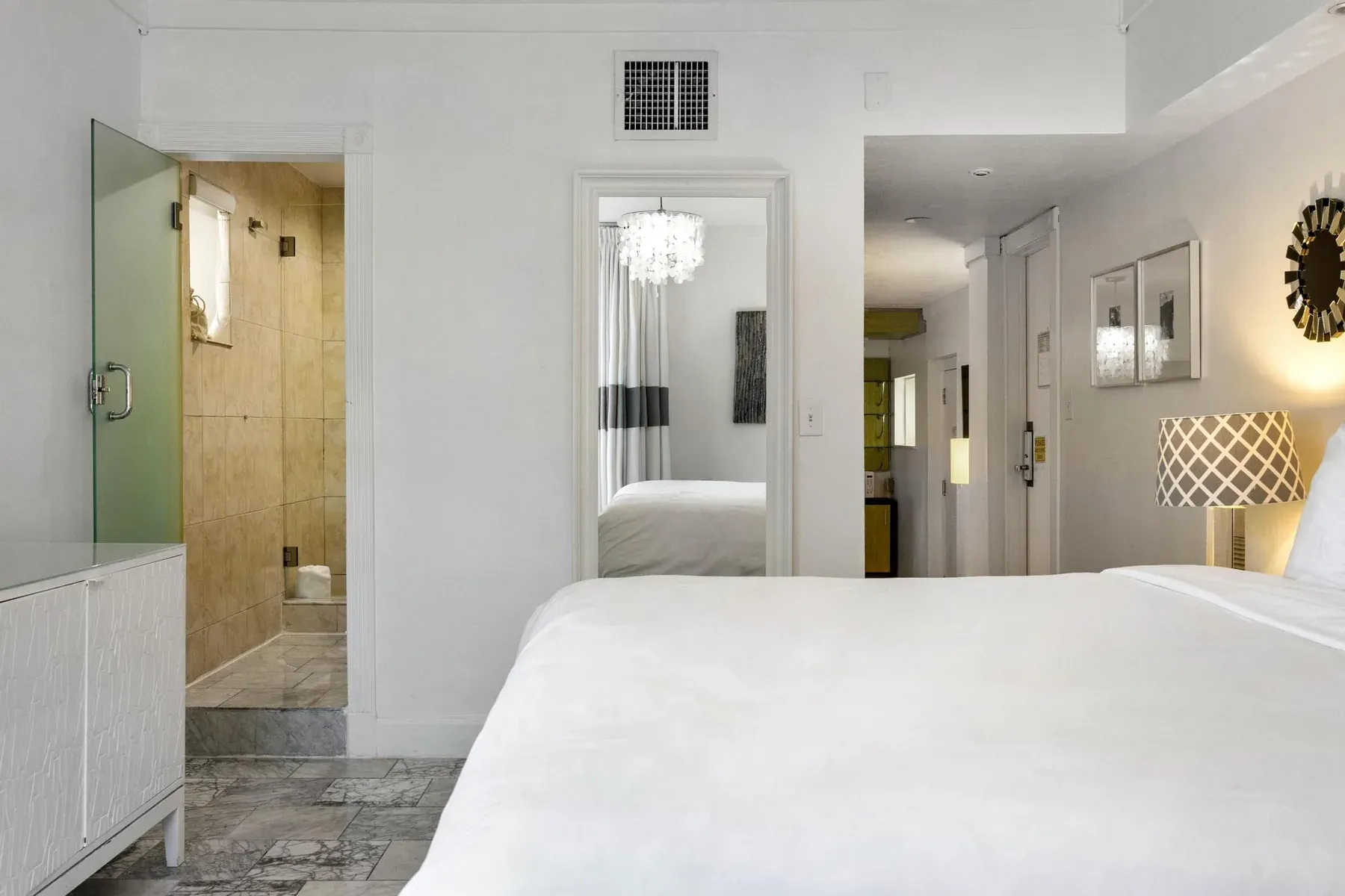 Looking through the suite entrance hall to the bedroom beyond